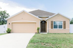 The front of the house has 2 2-car garages and fenced-in yard.