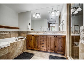 Refresh in our spacious bathroom, offering a double vanity, large tub, and elegant fixtures. A serene space for relaxation and self-care.