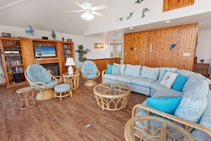 Enjoy the spacious Living Area with a Flat Screen TV and high ceilings!