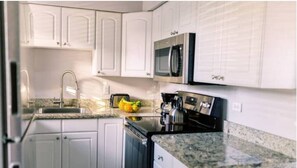 Discover culinary allure in our kitchen view, where the sink sparkles, the oven hums, and the microwave beckons. Stylish cabinets frame a space where every culinary creation is crafted in style and functionality. 