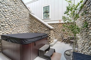 Unwind in the private hot tub nestled in a charming stone courtyard.