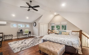 This extra unit keeps it clean with white siding, black trim, and a warm wood touch around the entrance. Big windows let in plenty of light and add to the contemporary aesthetic.