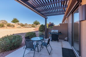 Back Patio Seating and Grill - The Back Patio includes an outdoor dining table, BBQ grill, and sliding glass door that leads into the living room.