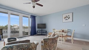 Living room with queen size sleeper sofa (sleeps 2) and access to balcony.