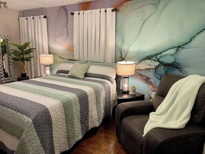 Unwind in this exquisite bedroom, complete w/a queen size bed, HDTV and recliner