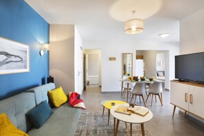 The living area is bright and cozy, perfect for relaxing after a day on the beach.