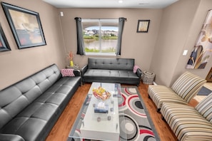 Spacious sitting area where you can watch the birds on the lake from the window.