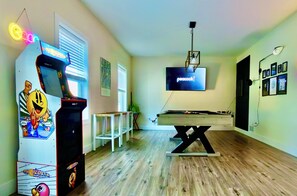 Game room with pool table, Pac-Man, darts & 65" TV for movies and sports.