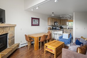 Family seating area with adjacent dining and kitchen
