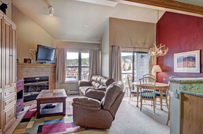 Enjoy the bright living area, featuring high ceilings, ample natural light, cozy seating, and a stylish decor.