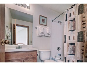 Refresh in the bright bathroom featuring modern fixtures, a shower/tub combo, and plenty of space.