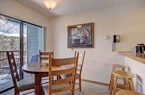 Enjoy meals in the cozy dining nook with a charming table, large windows, and a serene view.