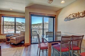 Dine in the scenic dining area with large windows, ample seating, and direct access to a private balcony for an al fresco experience.