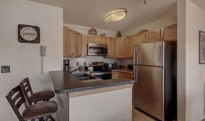 Well-equipped kitchen with modern appliances and a convenient breakfast bar for casual dining.