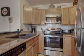 Stylish kitchen with stainless steel appliances and plenty of counter space for meal preparation.