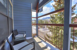 Private balcony with outdoor seating, perfect for enjoying mountain views and fresh air.