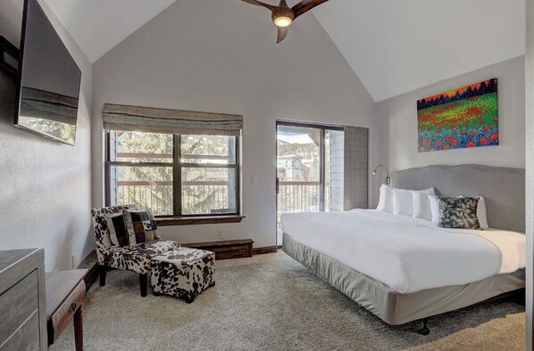 Spacious master bedroom with a comfortable king bed and plenty of natural light.