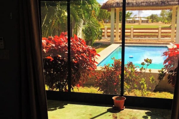 Looking at pool from the cottage's screened room.
