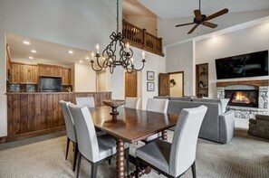Dine in style in the elegant dining area, offering high ceilings, a beautiful chandelier, and a large dining table for memorable meals.