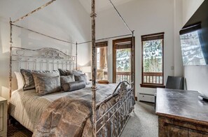 Sleep peacefully in the rustic bedroom, featuring a charming four-poster bed, cozy decor, and access to a private balcony with scenic views.
