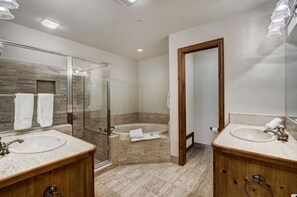Indulge in the luxurious bathroom, which includes a walk-in shower, soaking tub, and elegant fixtures for a spa-like experience.