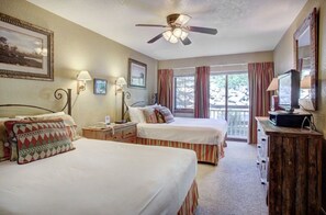 Unwind in the cozy bedroom, offering a king-sized bed, ceiling fan, and charming decor for a peaceful retreat.