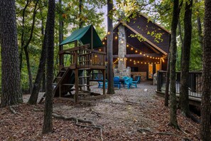Kids can play nearby on the play set with slide, rock wall, and clubhouse