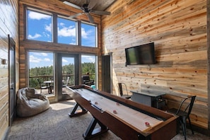 Shuffleboard and arcade in the game room loft