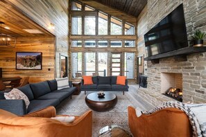Spacious living room on the main floor with floor-to-ceiling windows