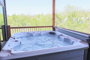 Hot tub with peaceful view of surrounding forest