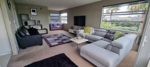 Plenty of comfy couches to relax on, upstairs lounge.  65" smart TV with Netflix