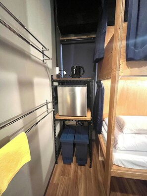 There is a refrigerator and a kettle