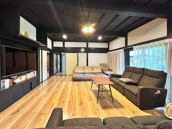 The spacious living room is equipped with high-speed Wi-Fi and a large TV, making it comfortable even for long stays.