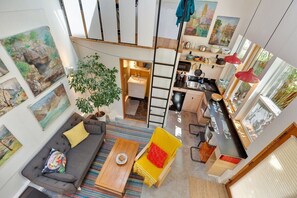 This is a view looking down into the studio kitchenette and dining counter, from the bedroom/office loft upstairs. The ladder goes to a second loft/office that will remain private/not included in this rental.