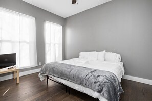 The ground level master bedroom features both a King sized bed, ceiling fan, and TV!
