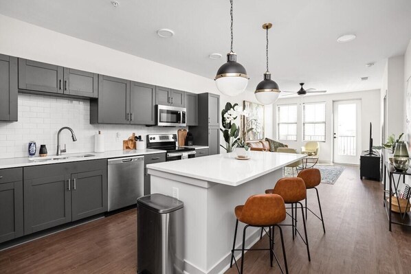 Pristine and modern kitchen space with bar seating for company