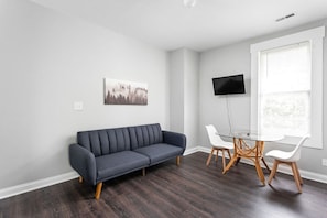 Our living room includes modern design, high-speed internet, and a plush sofa and chairs!