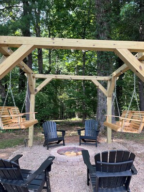 Outdoor firepit. Enjoy hanging on the swings around the firepit with friends.