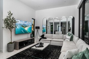 Spacious sofa seating with a smart TV for entertainment.
