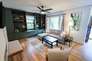 The spacious living room has plenty of seating and a Roku smart TV. 