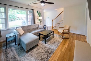 The spacious living room has plenty of seating and a Roku smart TV. 