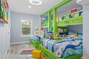Our bunk room is a dream come true for kids. They’ll enjoy the soft beds and bright colors. It’s close to the shared bathroom, so you can check on them easily.
