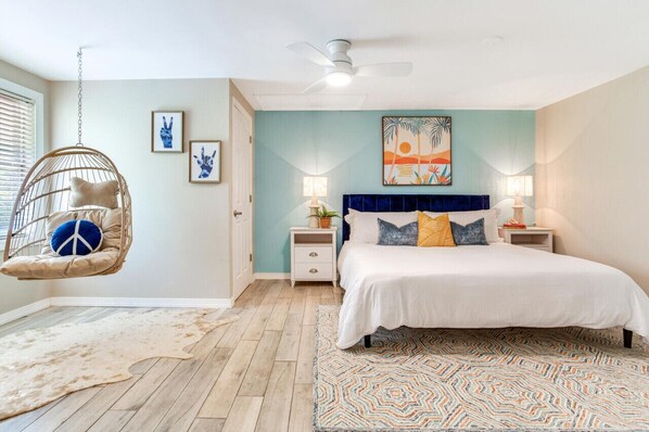 Unwind in the master bedroom featuring a king sized matress and hanging chair