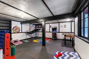Kid's playroom with Pop-a-Shot, foosball, arcade, giant Connect 4, cornhole etc.