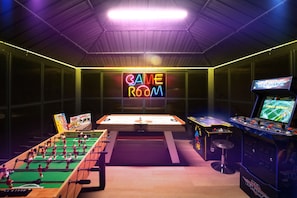 Step into our vibrant game room, equipped with foosball, air hockey, and classic arcade games, perfect for hours of entertainment.