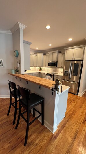 Kitchen with electric stove, electric tea kettle and 4c and 12c coffee pots
