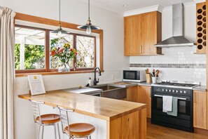 Kitchen with gas stove, microwave and cookings basics
