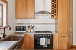 Kitchen with gas stove, microwave and cookings basics