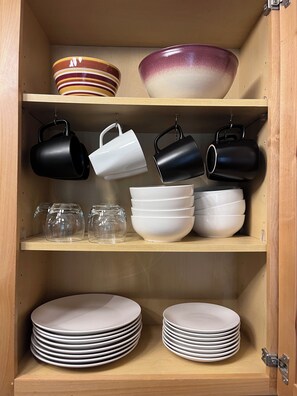 Kitchen well equipped with spices and cookware.