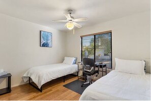 Guest bedroom twins with a desk for homework, or remote work for guests.